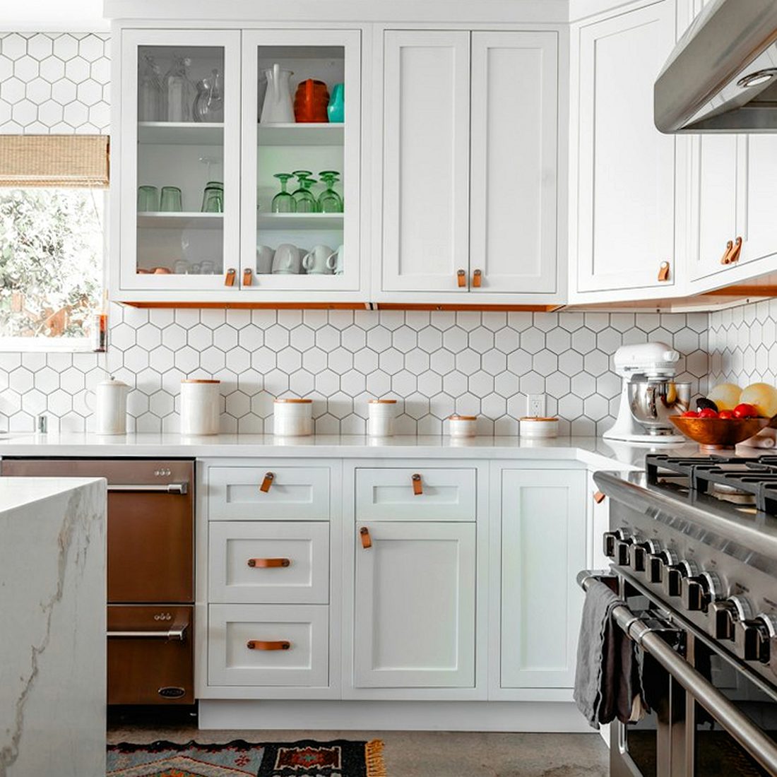 A fitted kitchen with cabinets, a cooker and a worktop